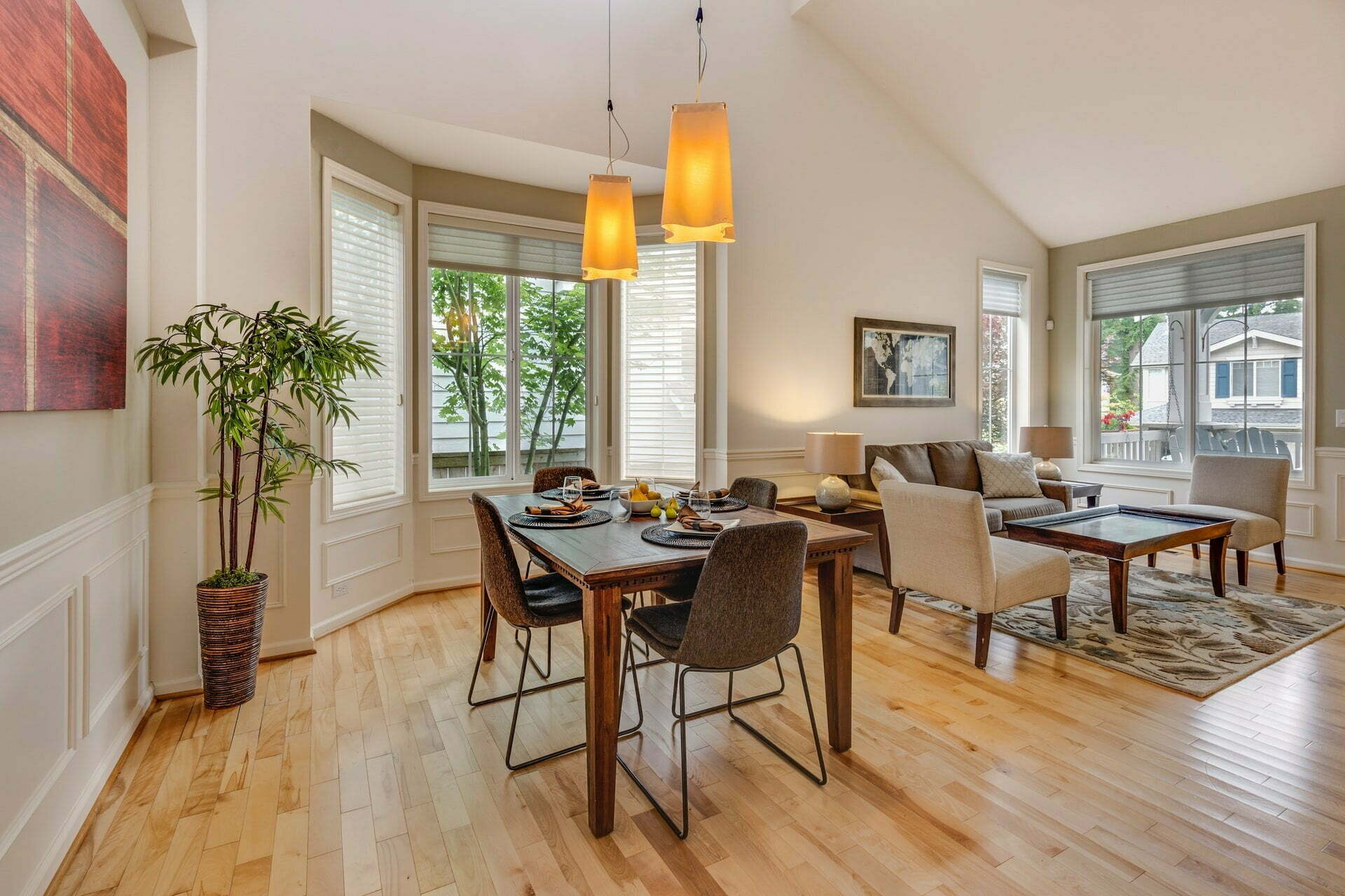 a large living room with a dining table and chairs